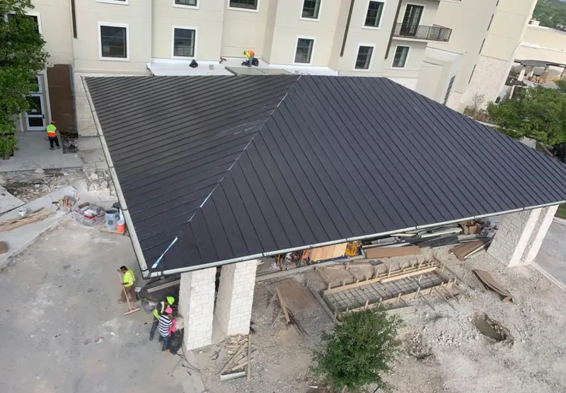 Metal roofing installation team working on a commercial building in Sultan